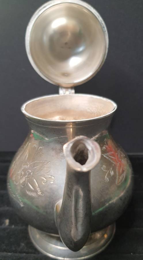 AN ANTIQUE SILVER PLATED TEA POT JUG SOLD AS IS