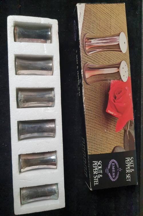 A VINTAGE SET OF SALT AND PEPPER SHAKERS IN ITS ORIGINAL PACKAGING SOLD AS IS