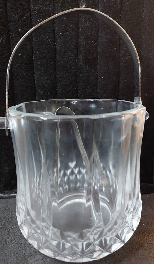 A FANCY CRYSTAL GLASS TYPE ICE BUCKET AND TONGS SOLD AS IS
