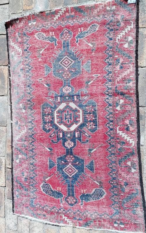 A VINTAGE MULTI-COLOURED PERSIAN RUG