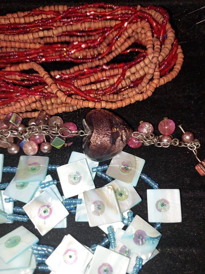 A COLLECTION OF DENSE MULTI STRAND NECKLACES SOLD AS IS