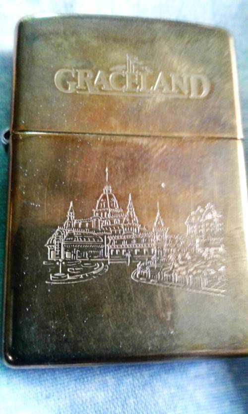 Brass Zippo cigarette lighter with Graceland Hotel Casino engraved detail.