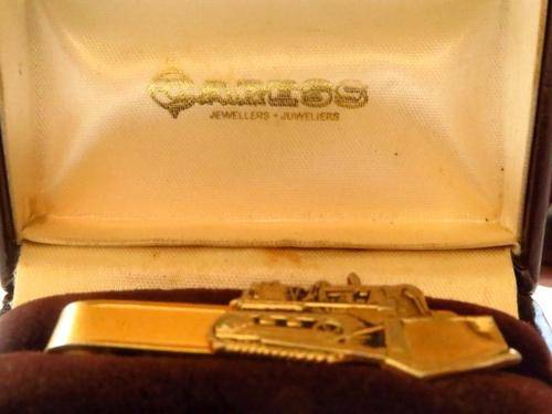 Vintage gold tone bulldozer tie pin in original Caress Jewellers box