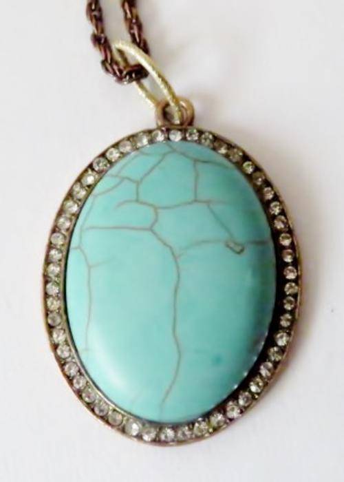 Vintage copper pendant with turquoise stone surrounded by rhinestones on a long bronze tone chain