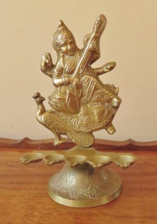 Vintage solid brass Hindu goddess Saraswati with 5 oil lamps on an engraved base