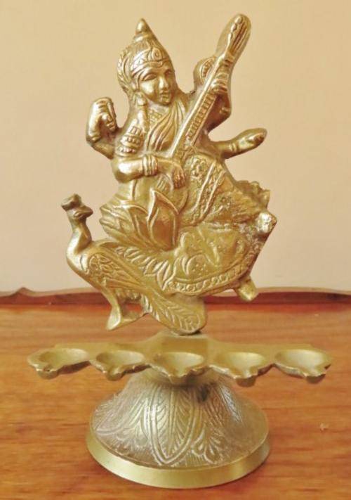 Vintage solid brass Hindu goddess Saraswati with 5 oil lamps on an engraved base