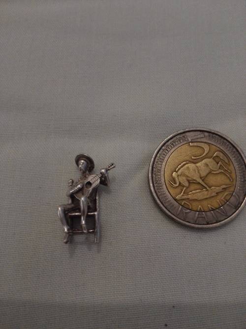 silver charm man with guitar