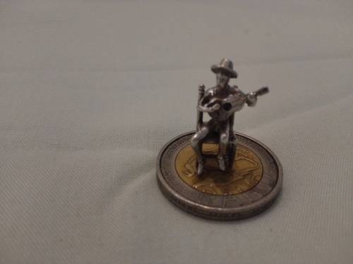 silver charm man with guitar