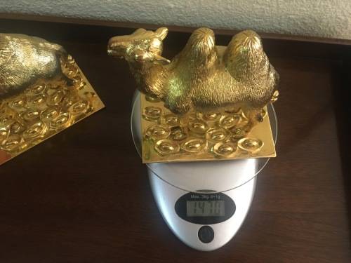 A Pair of Golden `World of Feng Shui` Camels