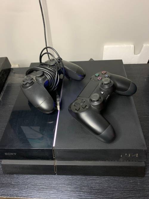 PlayStation 4 Original in original box with both a wired and wires less controller. Games included.