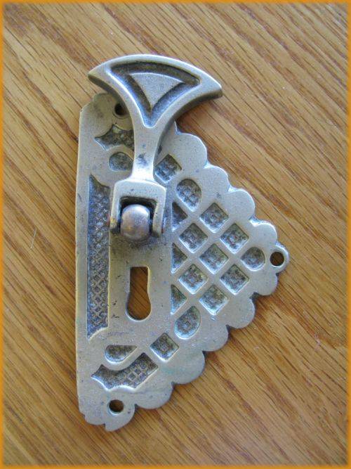 Brass keyhole cover.