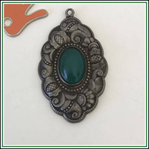 Antique silver repousse pendant with a green stone.