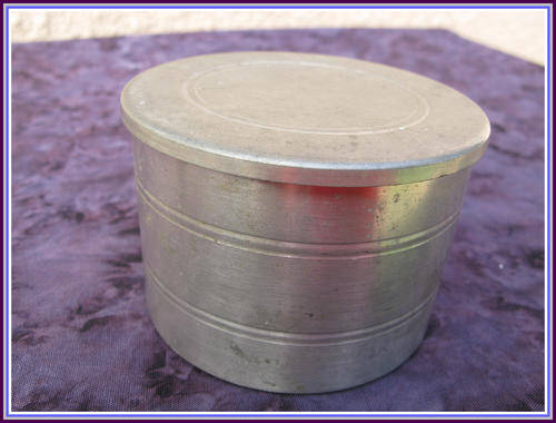 Pewter tea caddy with glass container inside.