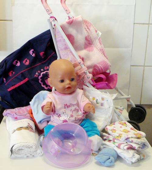ZAPF Creations - Baby Born Doll in Stroller with A Bag of Clothing and a Potty