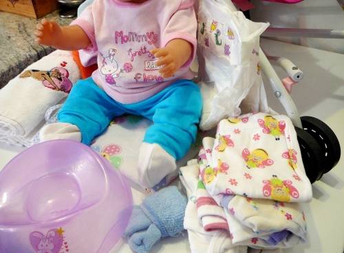 ZAPF Creations - Baby Born Doll in Stroller with A Bag of Clothing and a Potty
