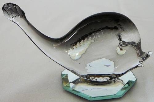 A Murano Glass Whale resting on an Octagonal Mirror