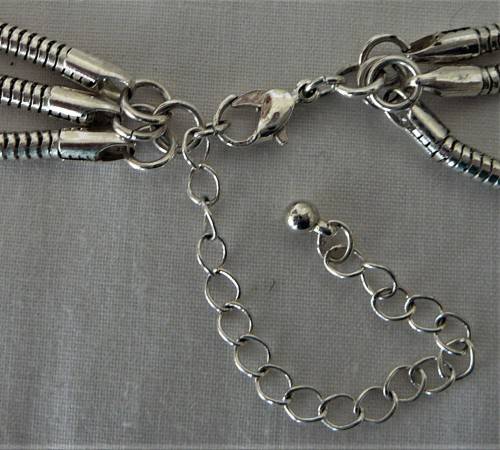 An Elegant Three Chain Silver Coloured Necklace