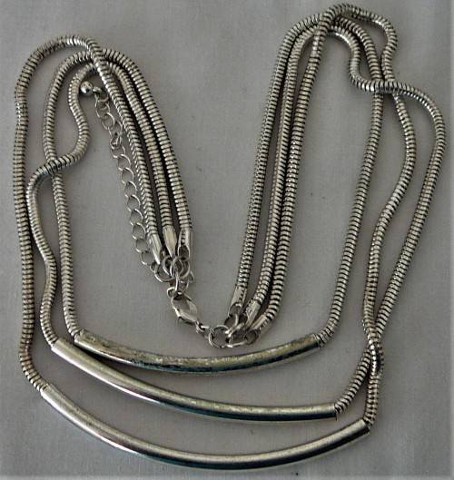 An Elegant Three Chain Silver Coloured Necklace