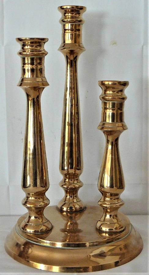 A Solid Brass Triple Candle Holder on a Round Base