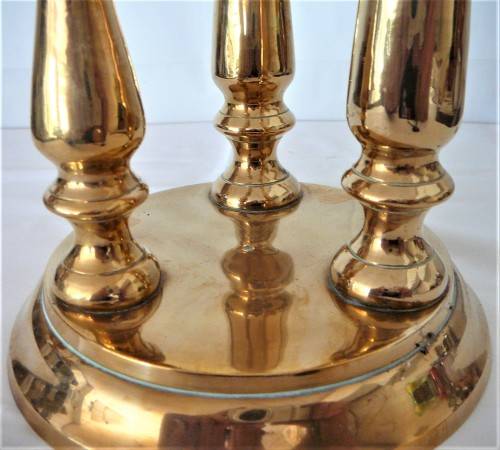 A Solid Brass Triple Candle Holder on a Round Base