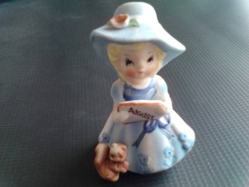 PORCELAIN FIGURINE - AUGUST GIRL, ORIGIN UNCERTAIN -READ BELOW.