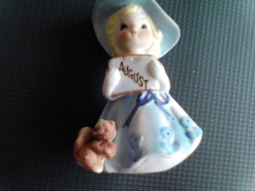 PORCELAIN FIGURINE - AUGUST GIRL, ORIGIN UNCERTAIN -READ BELOW.