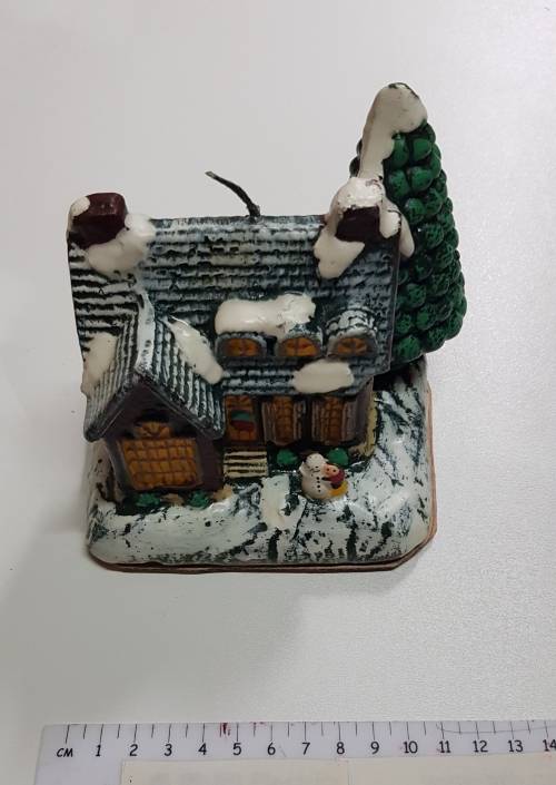 Vintage Christmas decoration. Christmas themed large candle depicting house in the snow.