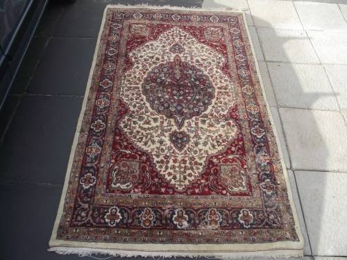 HAND WOVEN PERSIAN CARPET HAS AGE RELATED WEAR
