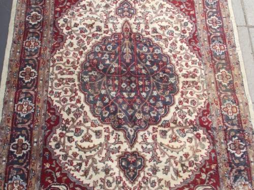 HAND WOVEN PERSIAN CARPET HAS AGE RELATED WEAR