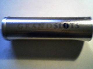 GRAND SLOTS TIN WITH LID. 9cm DIAMETER 31 cm HIGH.