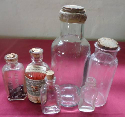 SIX DIFFERENT SIZE VINTAGE CLEAR CHEMIST-APOTHECARY BOTTLES WITH CORK STOPPERS- SEE PHOTOS
