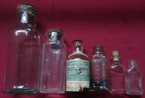 SIX DIFFERENT SIZE VINTAGE CLEAR CHEMIST-APOTHECARY BOTTLES WITH CORK STOPPERS- SEE PHOTOS
