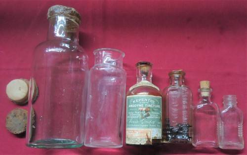 SIX DIFFERENT SIZE VINTAGE CLEAR CHEMIST-APOTHECARY BOTTLES WITH CORK STOPPERS- SEE PHOTOS