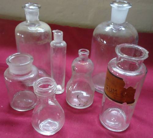 SEVEN DIFFERENT ROUND CLEAR VINTAGE CHEMIST-APOTHECARY BOTTLES-SEE PHOTOS