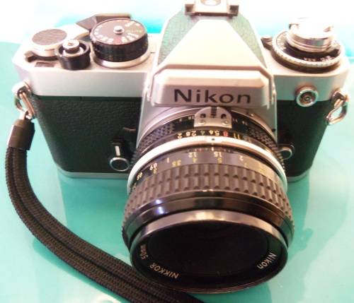 Nikon 1978 FE camera with 50 mm lens. Package-Vivitar 200 mm + 28 mm lenses and doubler in case.