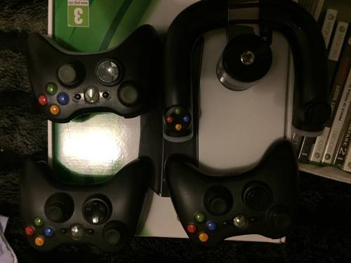 Xbox 360 slim 250G , 3 remotes , one charger , one steering wheel and 23 games