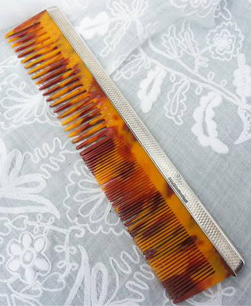 ENGLISH MADE, 1948 TORTOISE SHELL CELLULOID COMB WITH HALL MARKED SILVER TOPPING