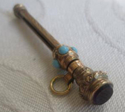 ANTIQUE ROLLED GOLD, NUT PICK WORN ON A FOB CHAIN OR CHATELAINE, SET WITH TURQUOISE AND AN AMETHYST