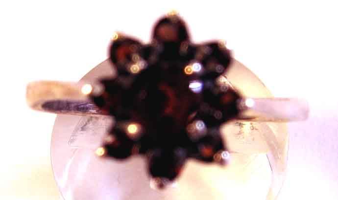STERLING SILVER RING SET WITH GENUINE GARNETS.