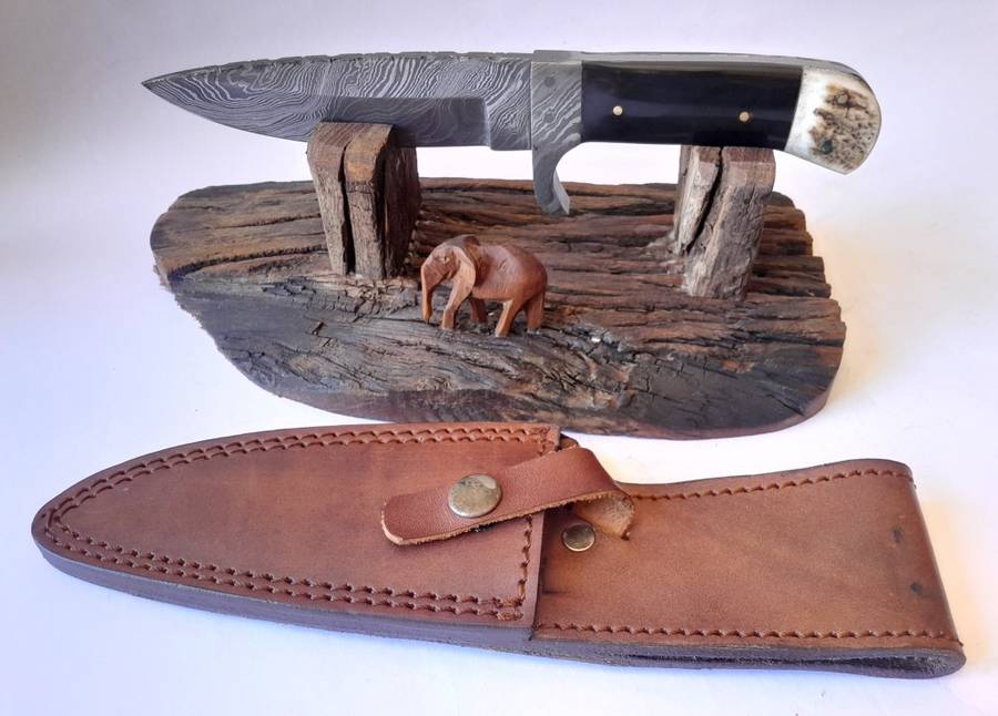 A Superb Damascus Blade Hunting Knife With Leather Sheath And Display Stand.