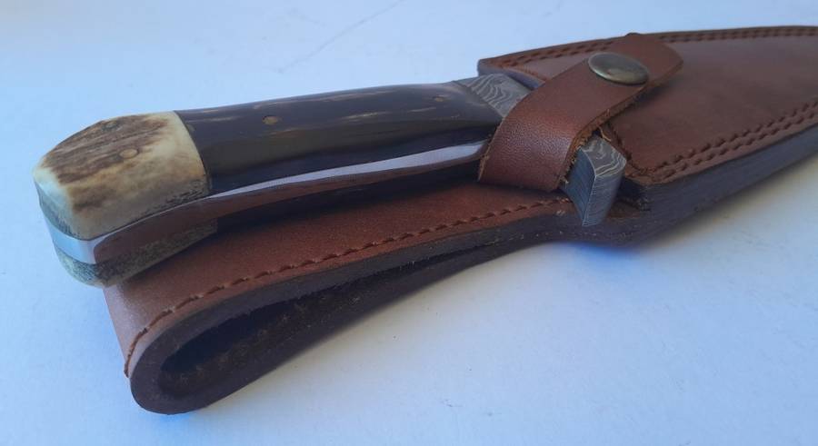 A Superb Damascus Blade Hunting Knife With Leather Sheath And Display Stand.