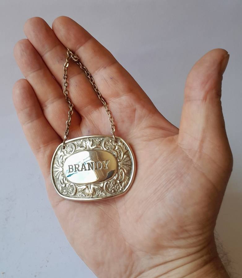 A Vintage Silver Plated `BRANDY` Bottle Decanter Label By `Ianthe, England`.