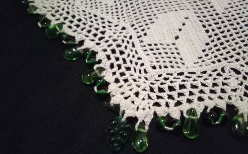 White Vintage crocheted jug cover with green glass beads