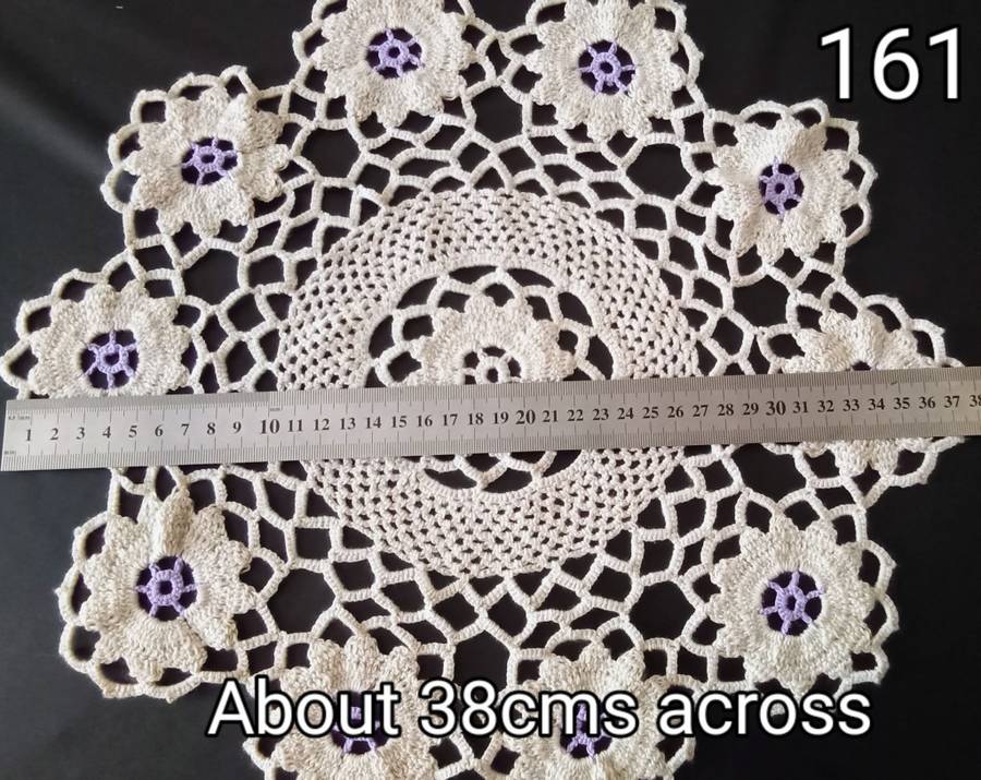 Lovely beige crocheted doily with purple flowers - about 38cms across