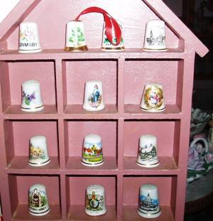 A large collection of  Thimbles And A Cabinet