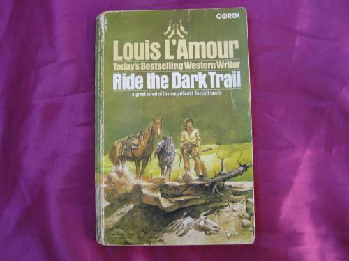 "Ride the Dark Trail" Soft cover. Louis L'Amour.