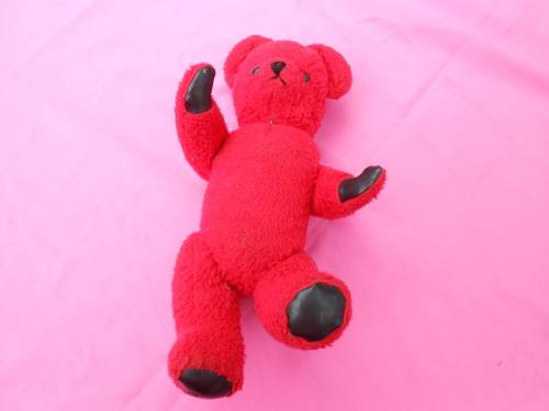 Red `Reindeer` label teddy bear.  Made in South Africa. 400mm high. Hole in right paw and foot.