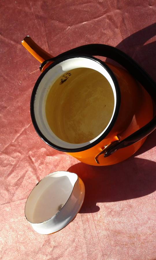 Enamel,  orange-coloured kettle.  Made in Poland.