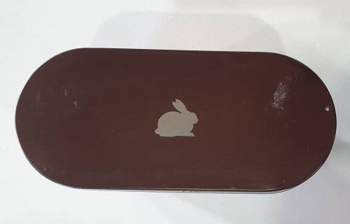 Brown tin with image of a rabbit as per photos