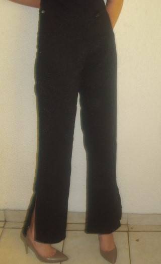 BOOTLEG BLACK PANTS WITH SILVER SPECKS AND SLIDS AT BOTTOM . SIZE 34. CONDITION VERY GOOD